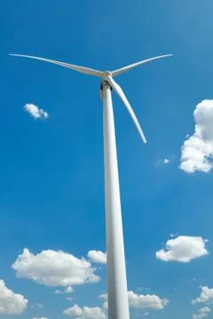 Electricity wind generator on bright cloudy sky background - wind energy and  Stock Photos
