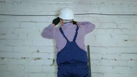 Electricity work, man repairs electric pole wearing all the safety equipment Stock Footage 150062860