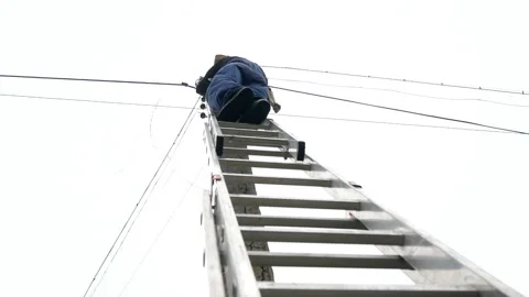Electricity work, man repairs electric pole wearing all the safety equipment Stock Footage 150647248