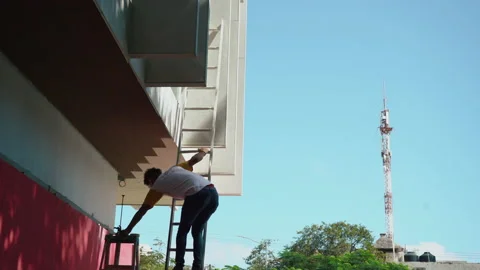 Electricity work, man repairs electric pole, climbing with a stair. Stock Footage 170978487