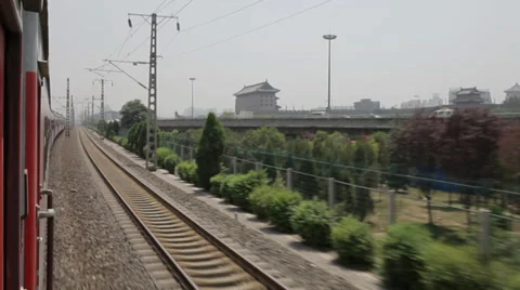An electrified passenger train moves through Xi'an city ,xi'an, shaanxi, china Stock Footage 37123045