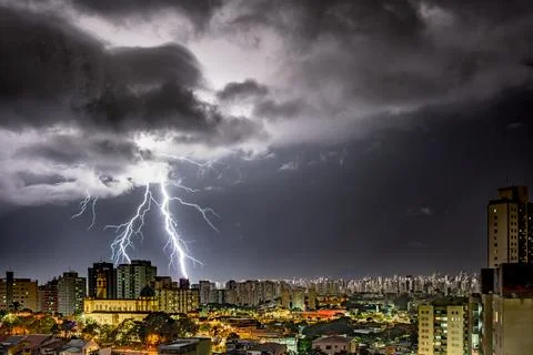 Electrifying Lightning Storm Over Cityscape Stock Photos