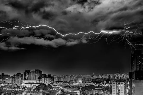 Electrifying Lightning Storm Over Cityscape Stock Photos