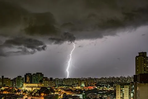 Electrifying Lightning Storm Over Cityscape Stock Photos
