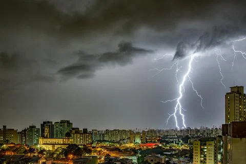 Electrifying Lightning Storm Over Cityscape Stock Photos