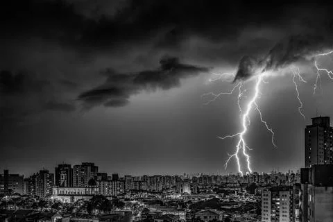 Electrifying Lightning Storm Over Cityscape Stock Photos