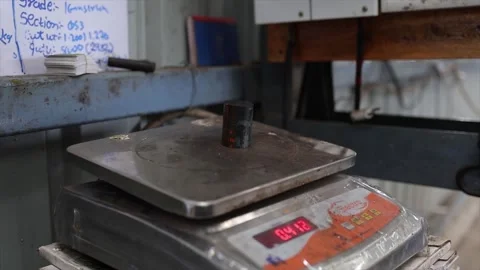The Electro scale's red LED display shows the weight 0.200, a critical step in Stock Footage 320681337