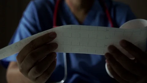 Electrocardiograph reading by a doctor Video stock 100975420