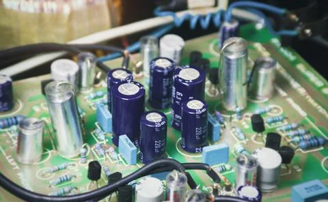 Electrolytic capacitor row on electronic circuit board Stock Photos