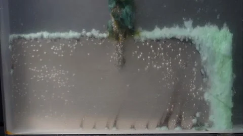 Electrolytic mud collects on anode during electrolysis, seen in time-lapse. Stock Footage 320465770