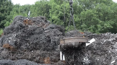 Electromagnet on crane sorting scrap metal at scrapyard Stock Footage 51428818