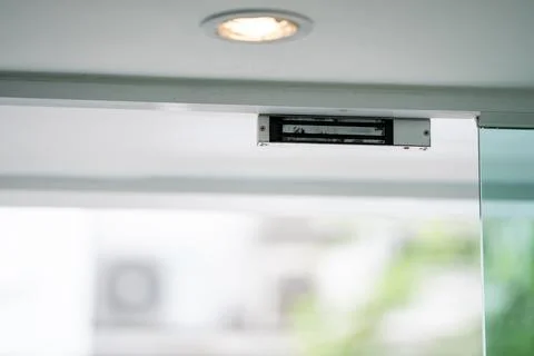 Electromagnetic door lock installed on a modern entrance provides secure ac.. Photos