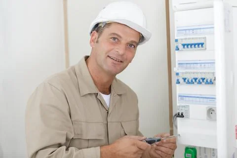 An electromechanic cabling a connection Stock Photos