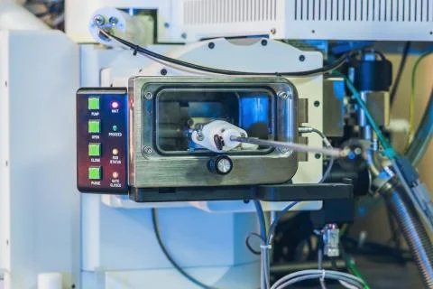 An electron microscope gateway. Putting a sample into a microscope. Stock Photos