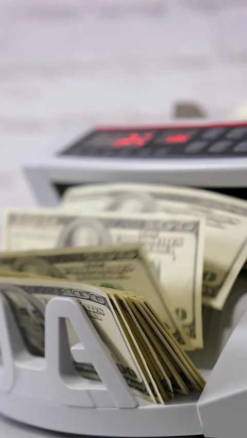 Electronic bill counter processing stack of hundred dollar banknotes for ba.. Stock Footage 337545053