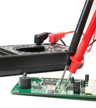 Electronic boards and digital multimeter Stock Photos