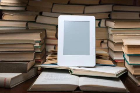 Electronic book on background of regular old books Foto stock