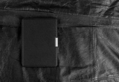 Electronic book in the case on leather background Stock Photos