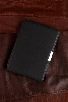 Electronic book in the case on leather background Stock-Fotos