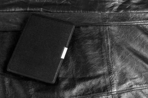 Electronic book in the case on leather background Stock Photos
