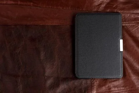 Electronic book in the case on leather background Foto stock