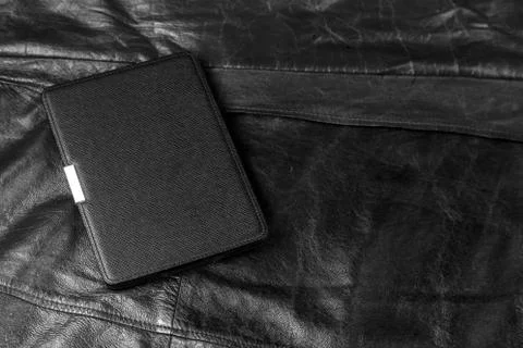 Electronic book in the case on leather background Stock Photos