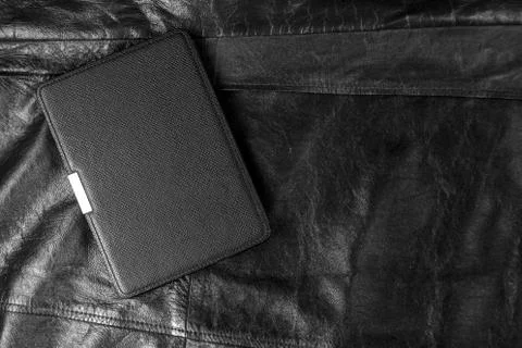 Electronic book in the case on leather background Stock Photos