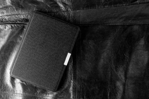 Electronic book in the case on leather background Stock Photos