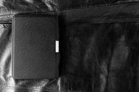 Electronic book in the case on leather background Stock Photos
