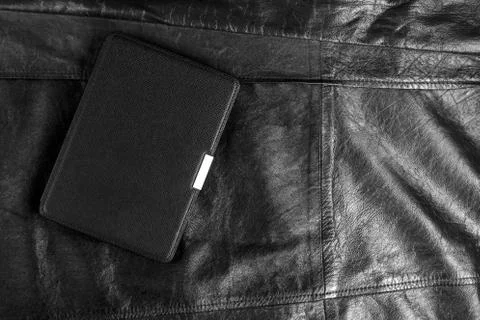 Electronic book in the case on leather background Stock Photos