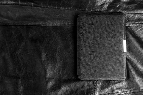Electronic book in the case on leather background Stock Photos