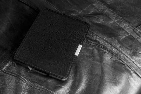 Electronic book in the case on leather background Stock Photos