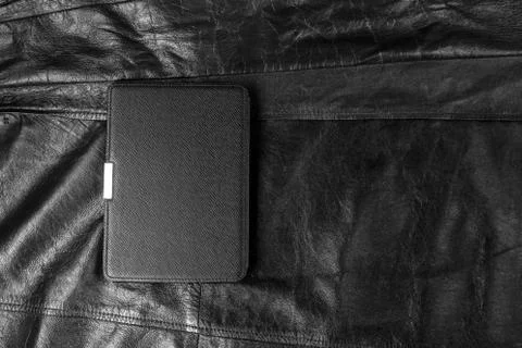 Electronic book in the case on leather background Stock-Fotos