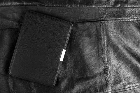 Electronic book in the case on leather background Stock Photos