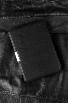 Electronic book in the case on leather background Stock Photos