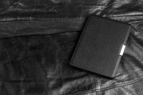 Electronic book in the case on leather background Stock Photos