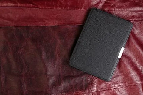 Electronic book in the case on leather background Stock-Fotos