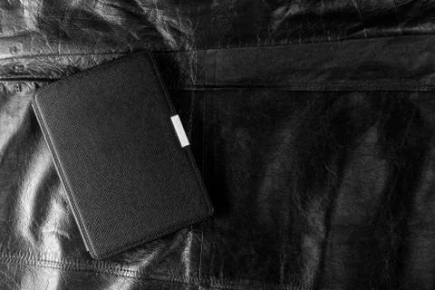 Electronic book in the case on leather background Stock Photos