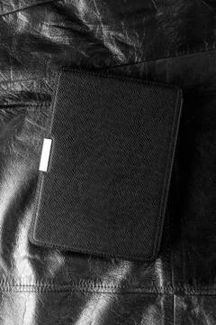 Electronic book in the case on leather background Stock Photos