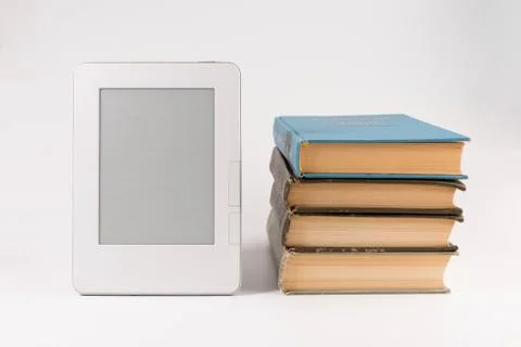 Electronic book with stack of regular old books isolated on white background Stock Photos