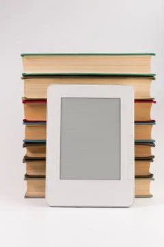 Electronic book with stack of regular old books isolated on white background Stock Photos