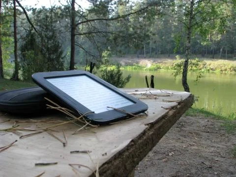 Electronic book on a wooden table in nature Stock Photos