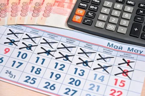 Electronic calculator and banknotes of five thousand rubles are on the calend Stock Photos