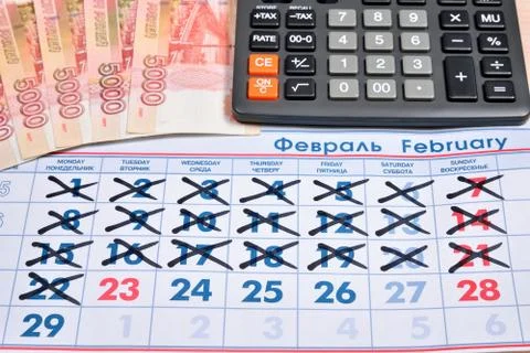 Electronic calculator and banknotes of five thousand rubles are on the calend Stock Photos