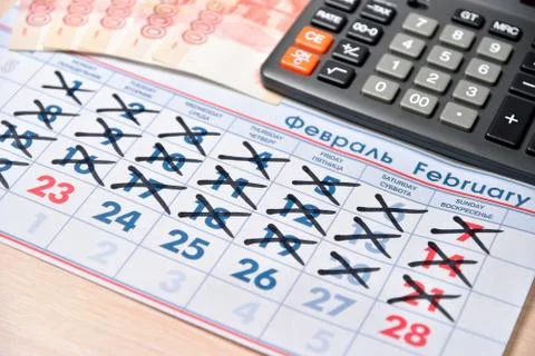 Electronic calculator, banknotes of five thousand rubles, calendar with holid Stock Photos