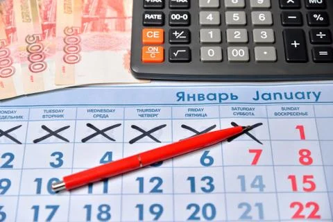 Electronic calculator, red pen, notes of five thousand rubles are on the cale Stock Photos