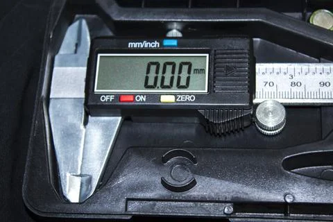 Electronic caliper on a dark table Stock Photos
