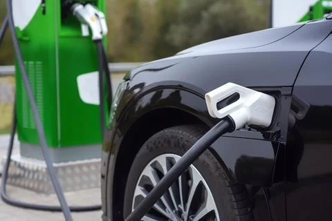 Electronic charging for electro car. EV car charging station in sity. Nature  Stock Photos