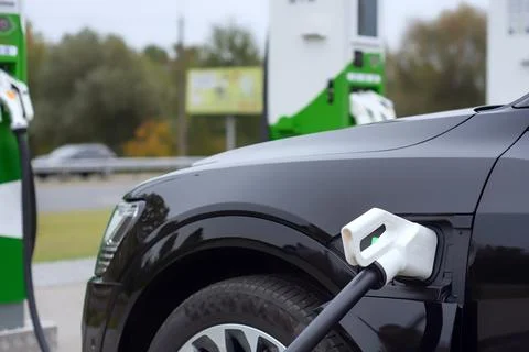 Electronic charging for electro car. EV car charging station in sity. Nature  Stock Photos