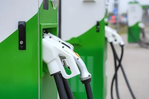 Electronic charging for electro car. EV car charging station in sity. Nature  Stock Photos